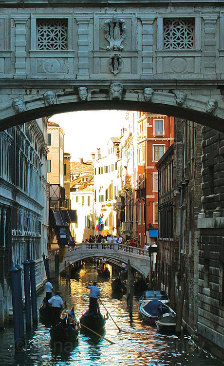 Gondolas passing under the bridge of sighs in venice